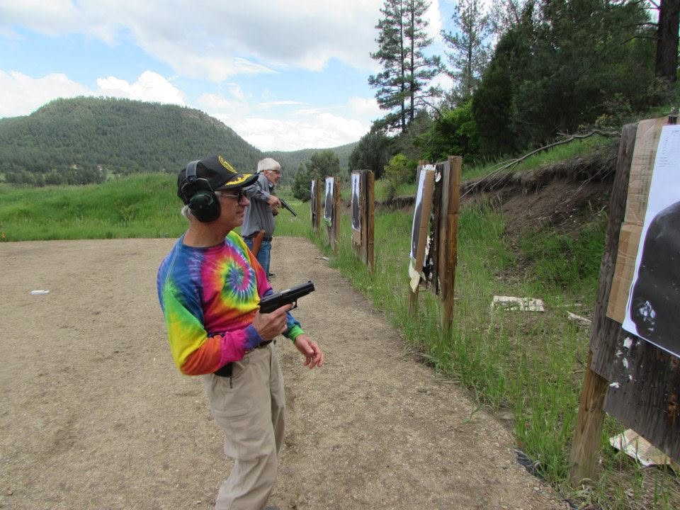 Shooter on the line with the San Juan mountains behind