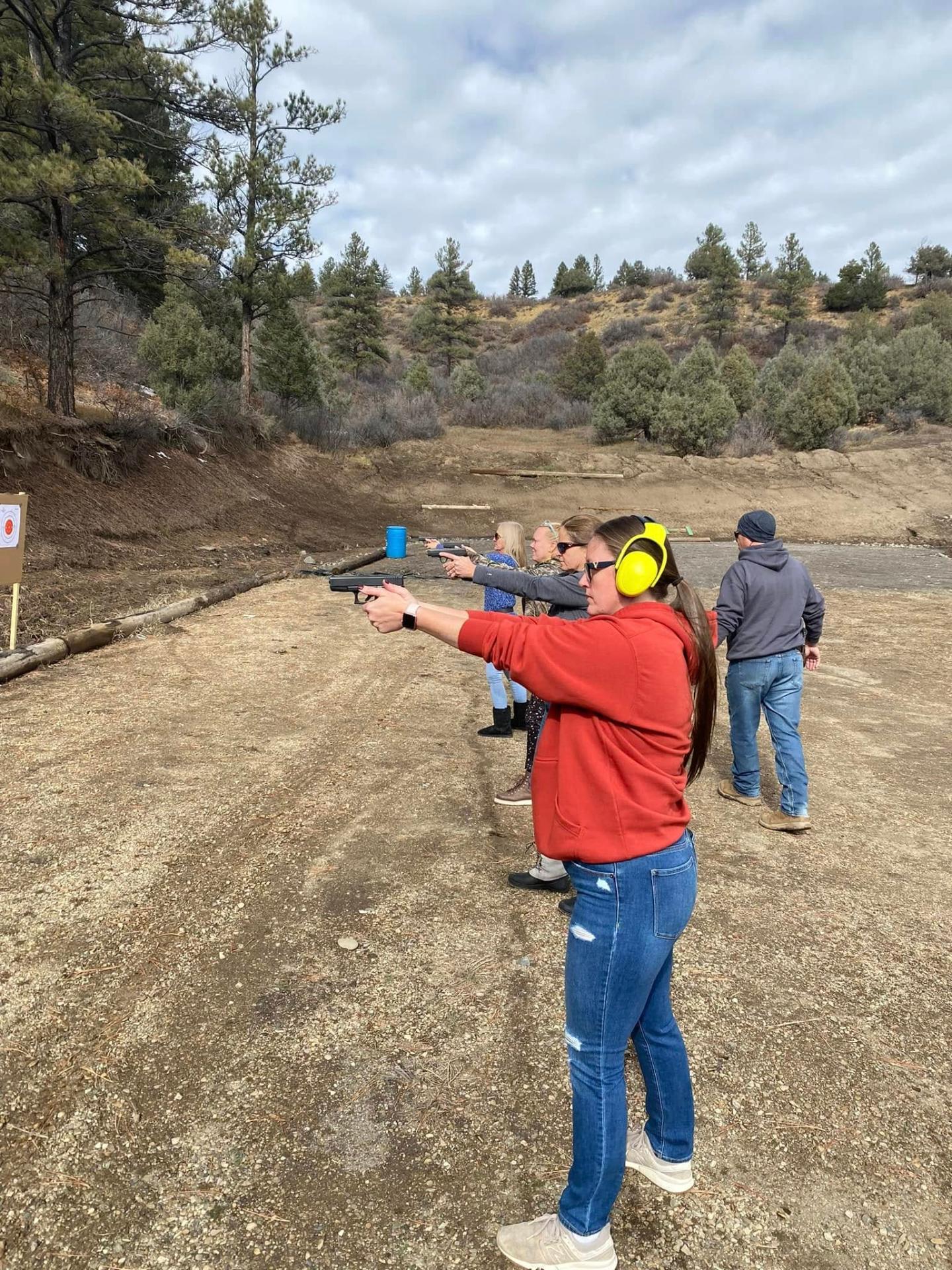 Student in a red hoodie firing on the line with her group
