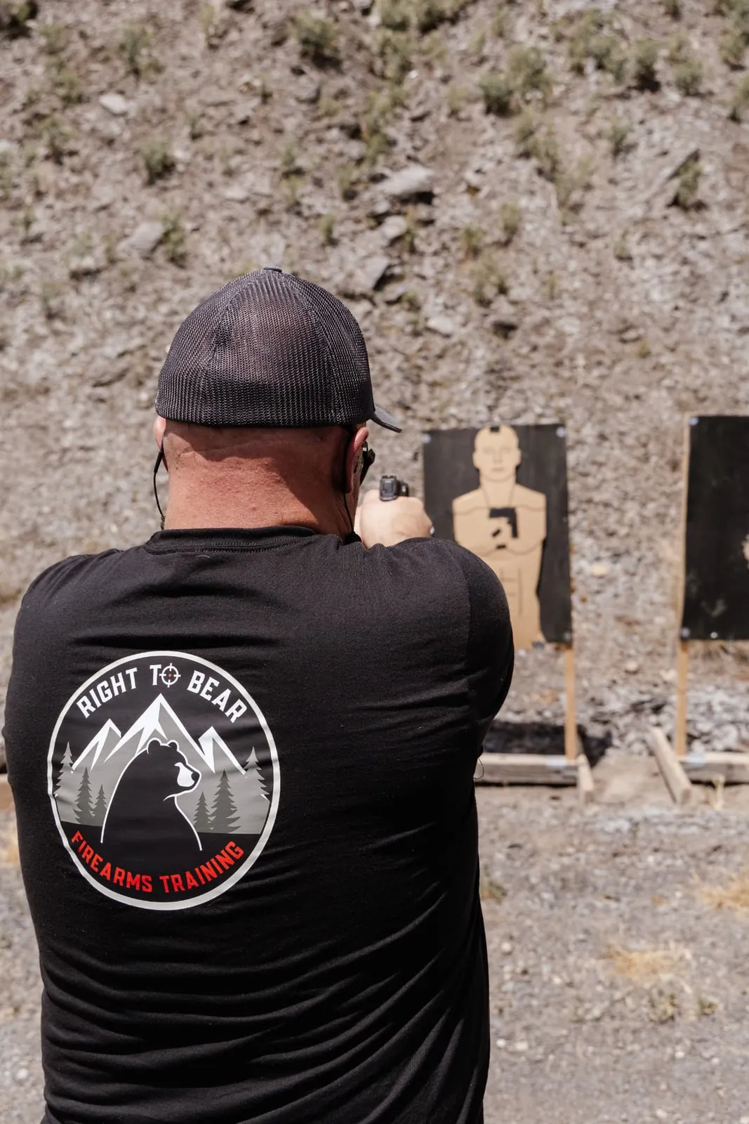 Instructor in a Right to Bear tee shooting at a silhouette target