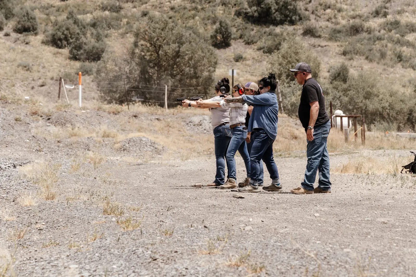 Instructor coaching a group of women on the firing line