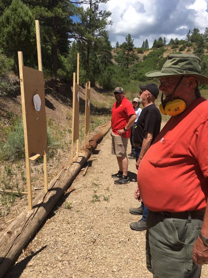 Instructor walking the bay between students and targets