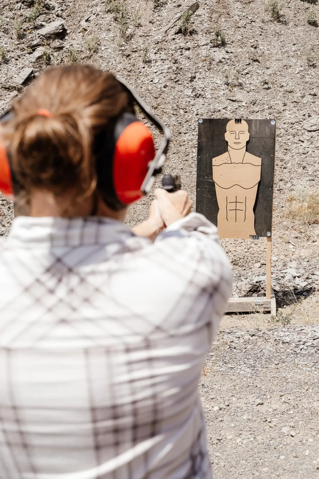 Student in ear protection squared up on her silhouette target